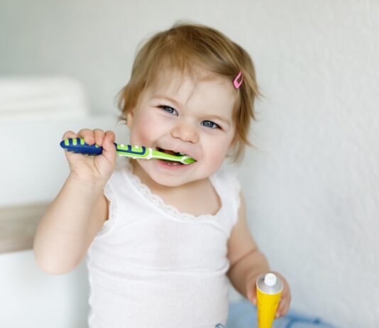 How to Make Brushing Fun (and Effective) for Toddlers child brushing teeth